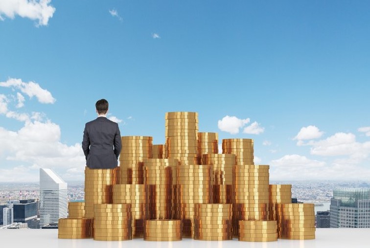 immobilienvermoegen-versus-geldvermoegen Geldmünzen Türme